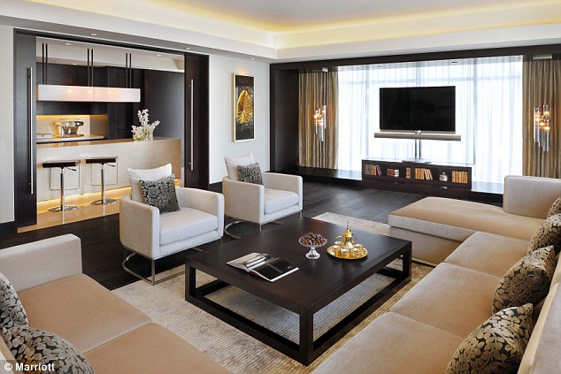 Everything you could need: The living room in one of the hotel suites has a large sofa, bar and flat screen TV 